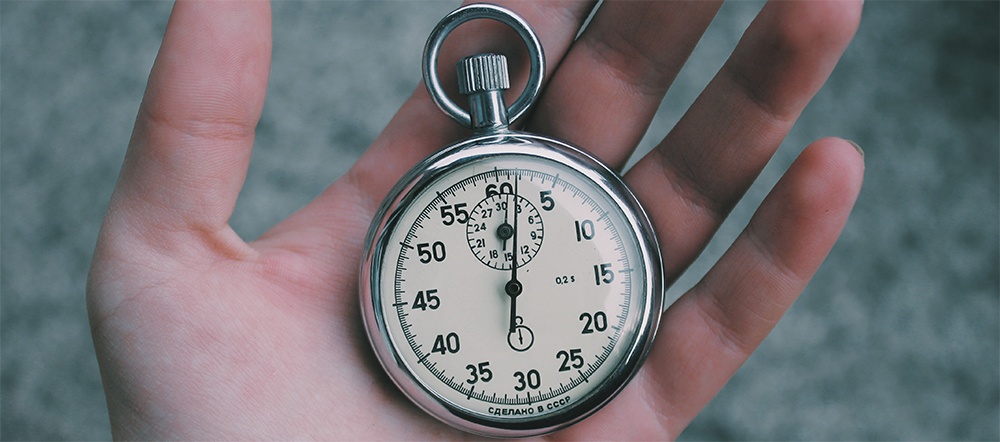 hand holding a watch symbolizing that it's time to hire a warehouse manager